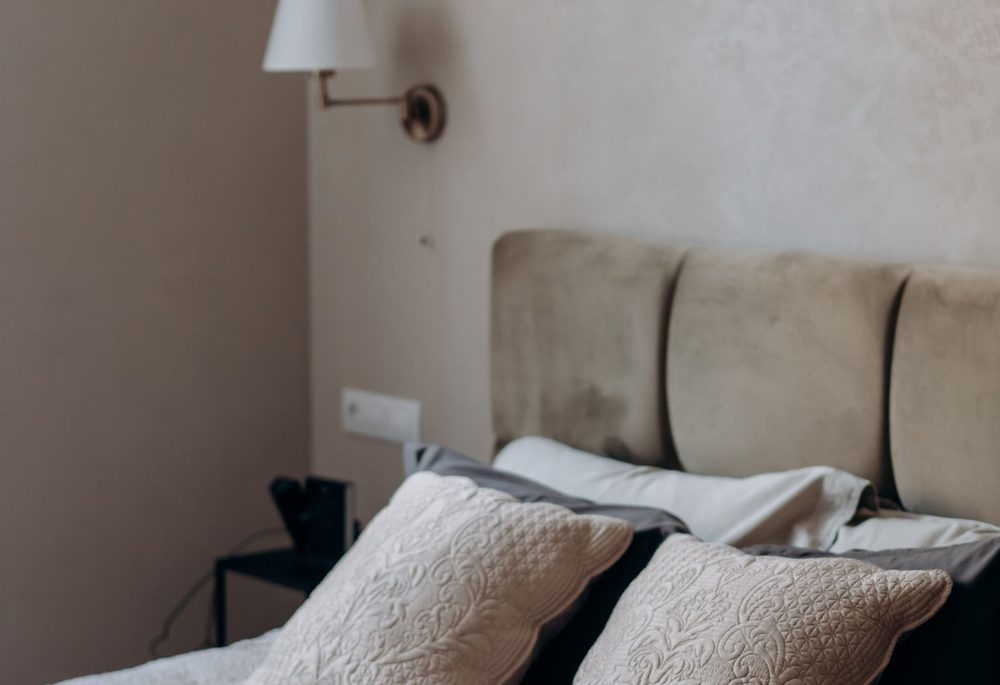 Quiet bedroom with an upholstered headboard against a shared party wall