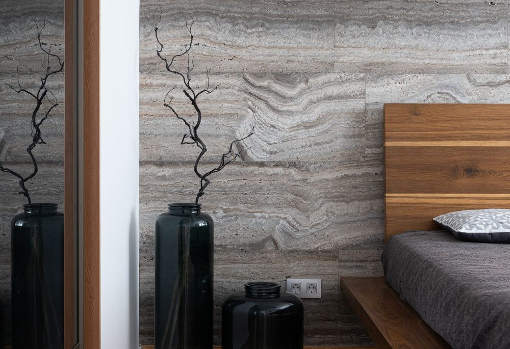 Bedroom with a solid wall behind the bed, the surface most often treated for neighbour noise