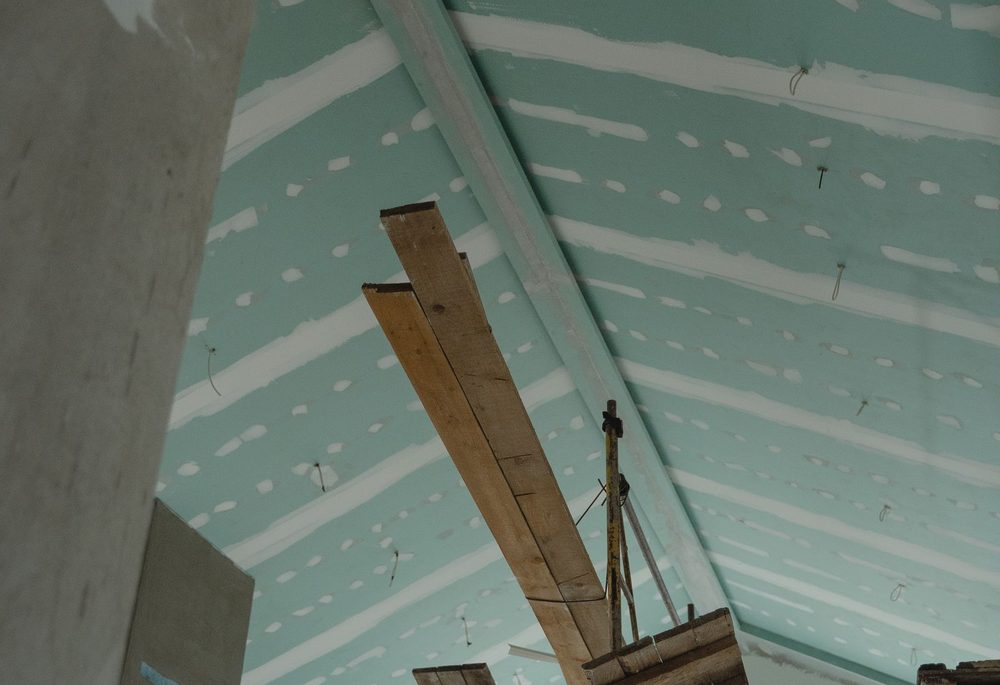 Ceiling boards fixed to a suspended frame, viewed from below