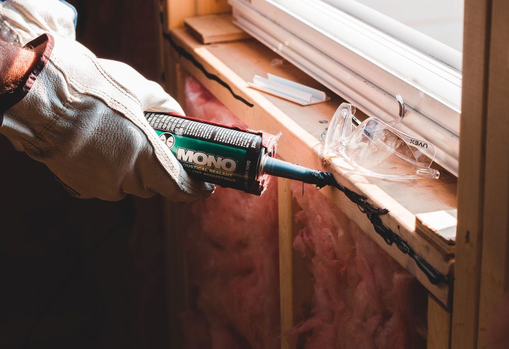 Acoustic sealant applied around a window frame to close an air gap